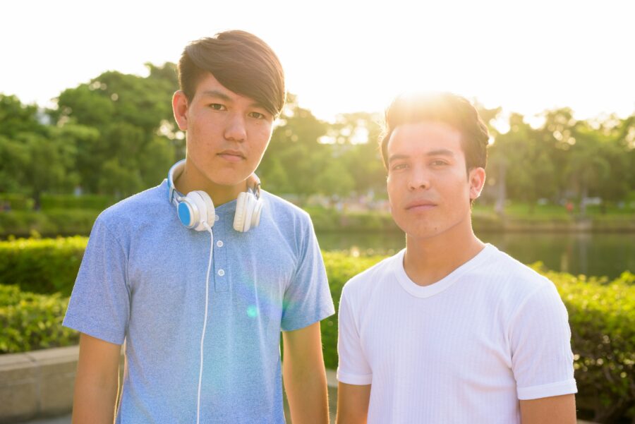 Young Asian man and young Asian teenage boy at the park together