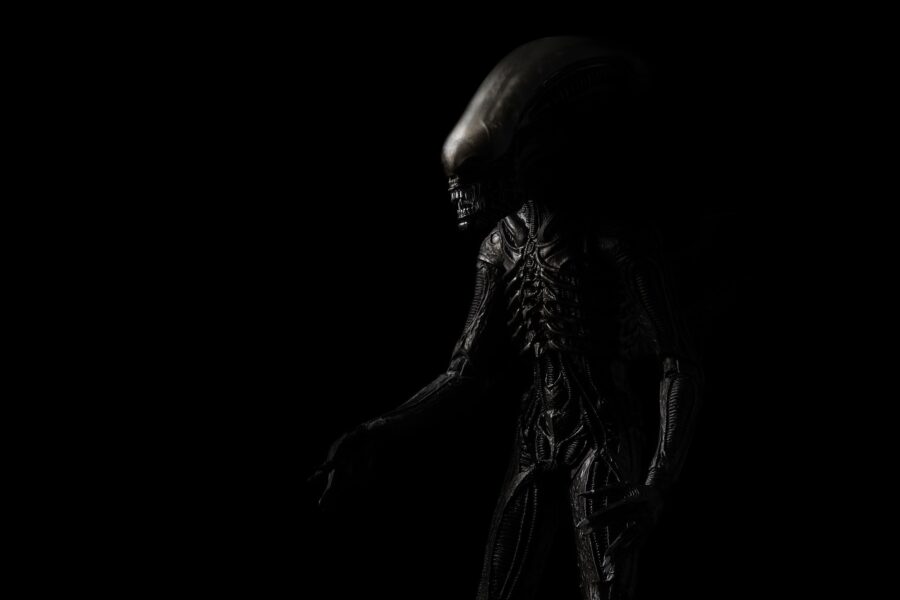 Alien (xenomorph) comes out of the dark shadow (close up)