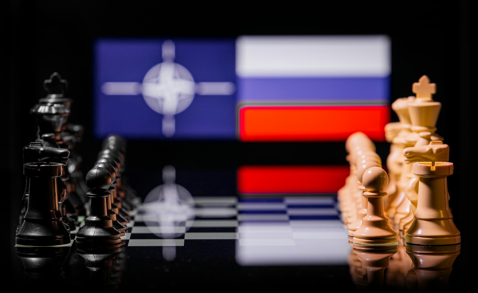 Conceptual image of war between Russia and NATO using chess pieces and national flags