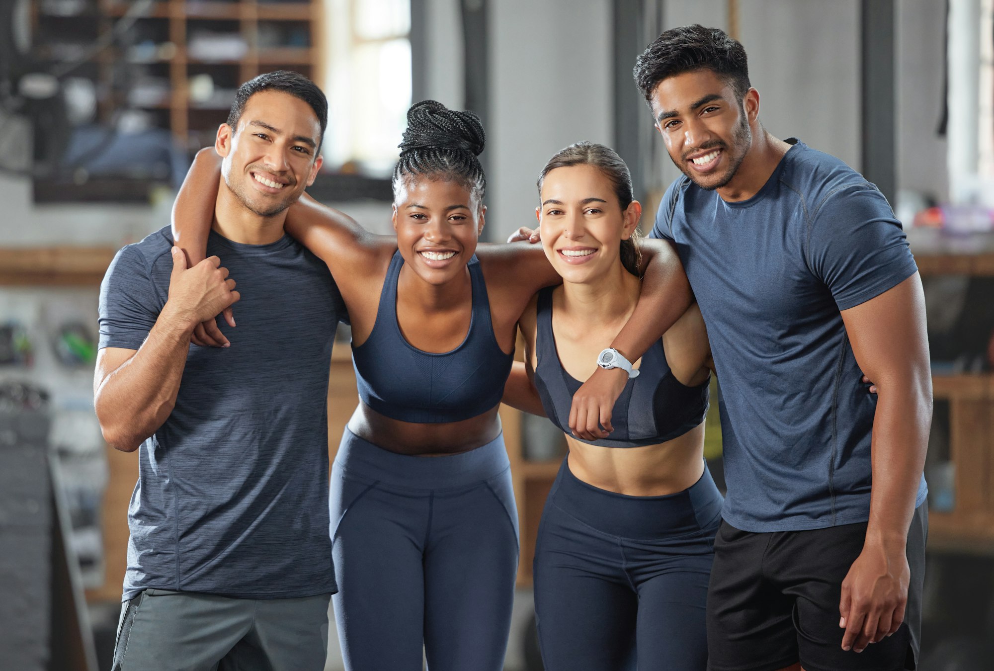 Fitness, exercise and diverse accountability group standing together and looking happy after traini