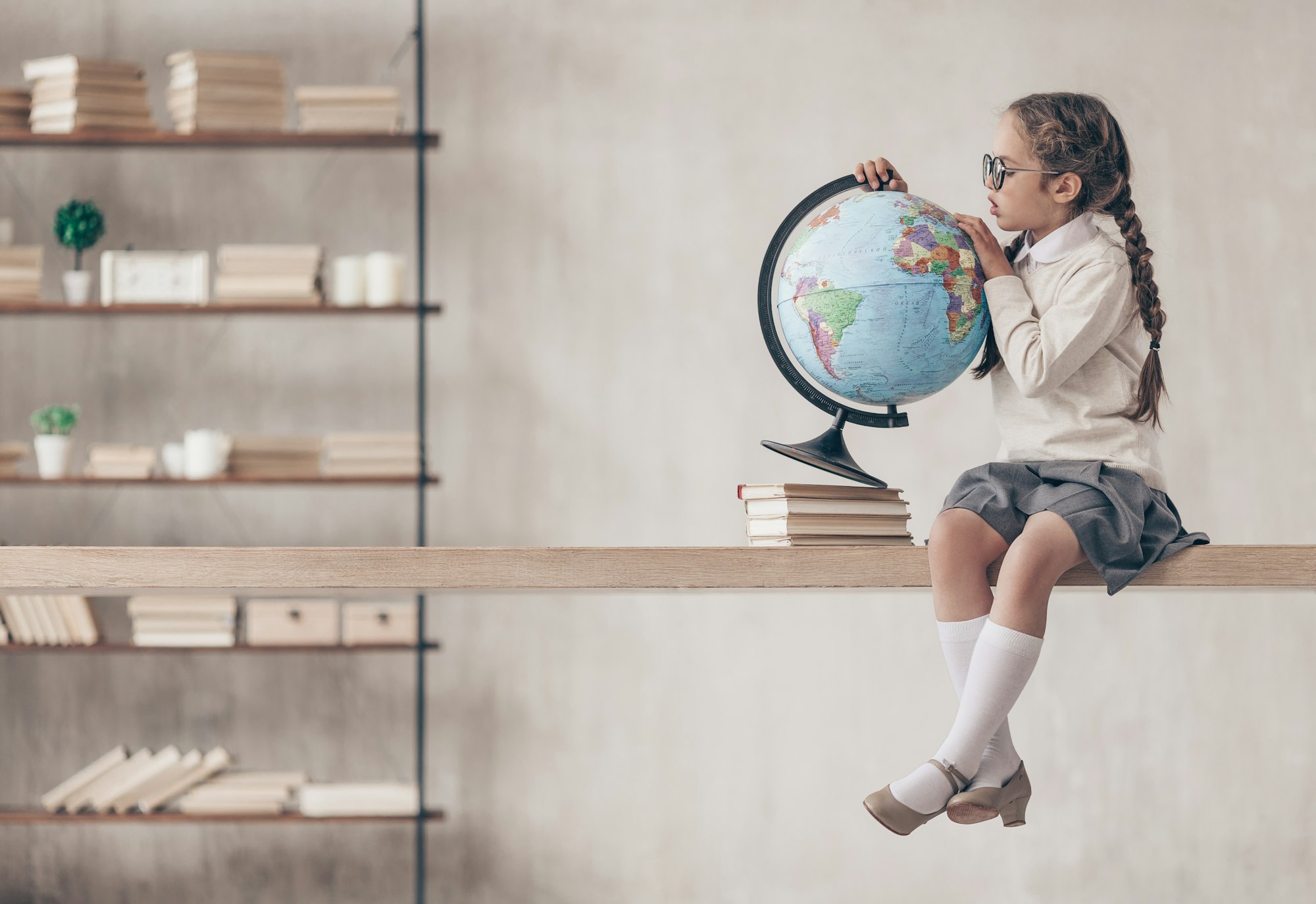 Little schoolgirl with a globe