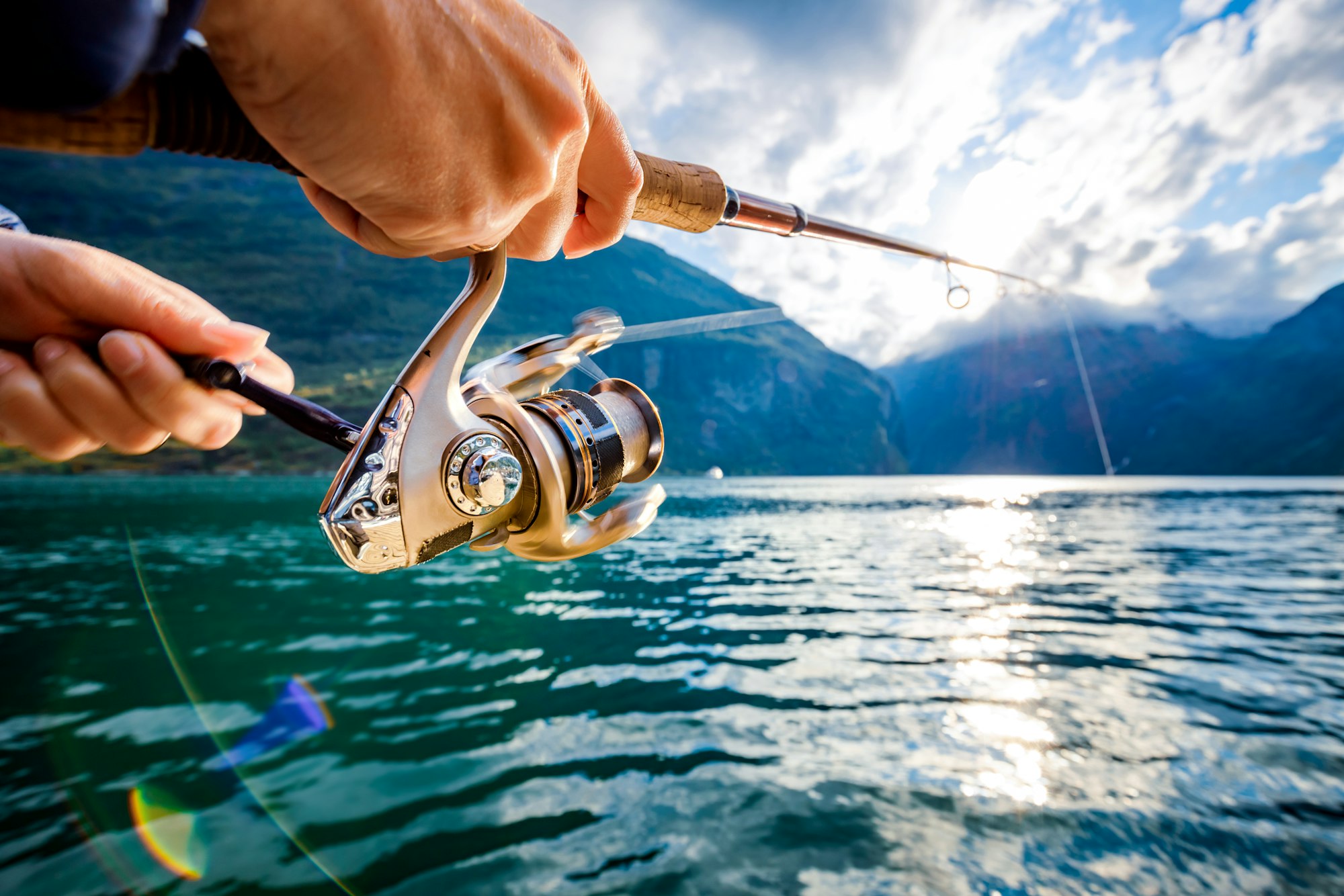 Woman fishing on Fishing rod spinning in Norway.