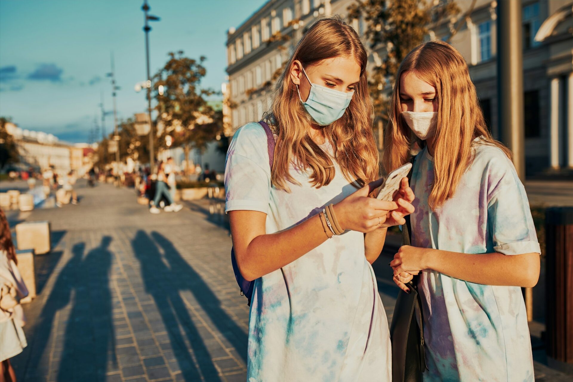 Young women girls using smartphones using social media sending texts watching photos and videos