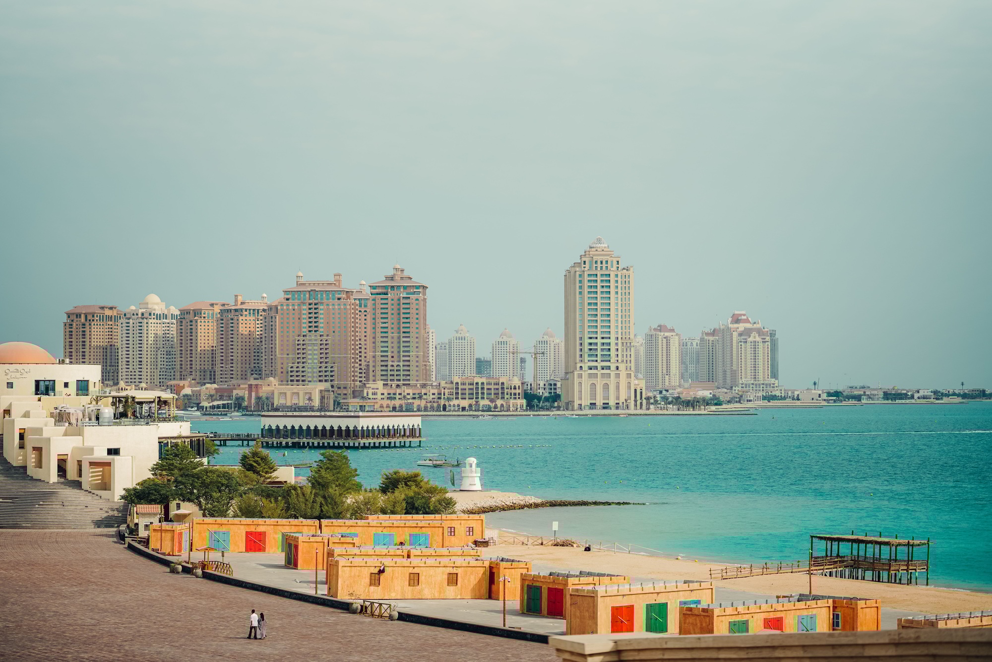 Panoramic view of modern high-rise buildings along the waterfront in Doha, Qatar