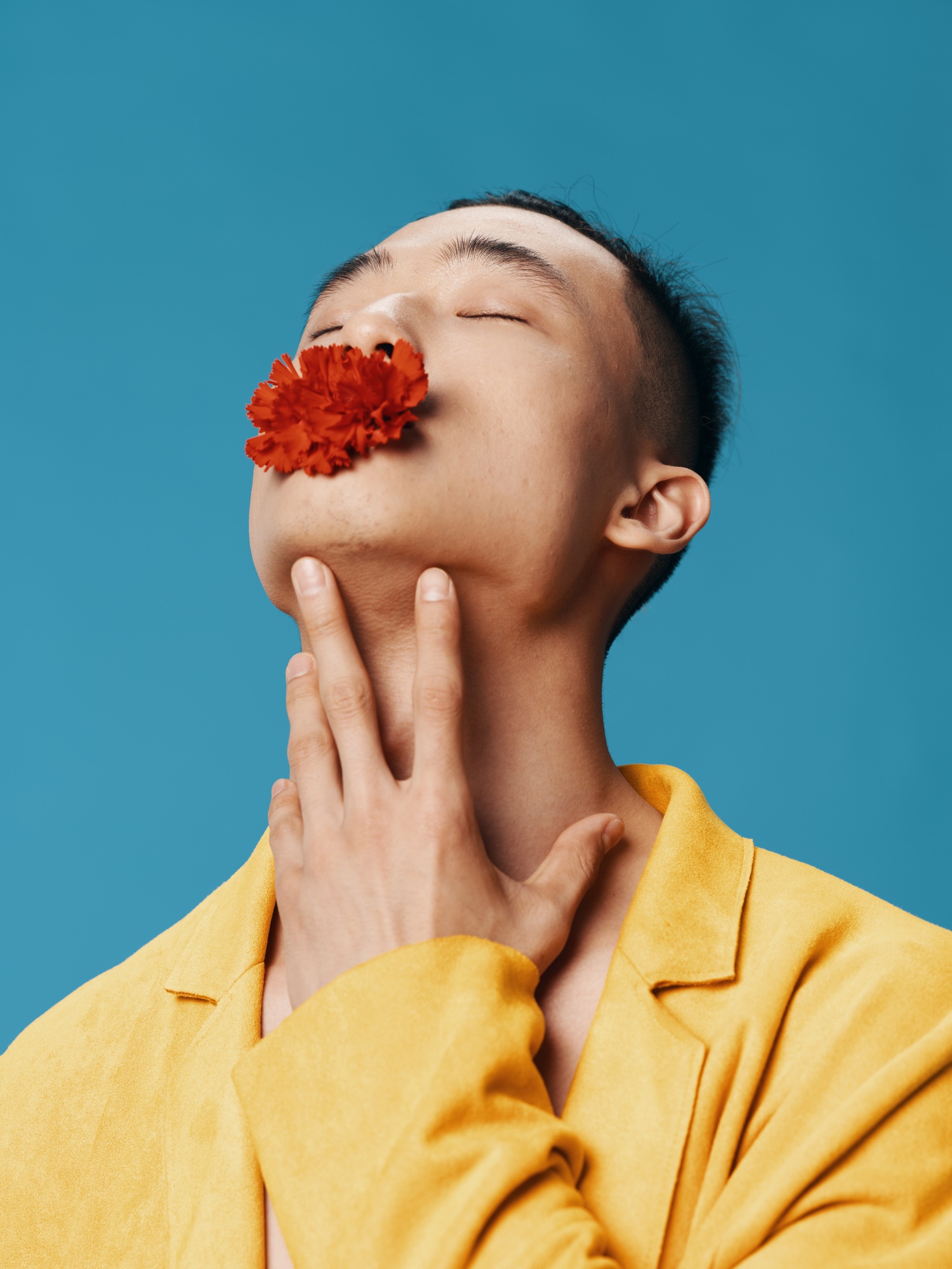 A social machine with a red flower in its mouth tilted its head back Asian appearance