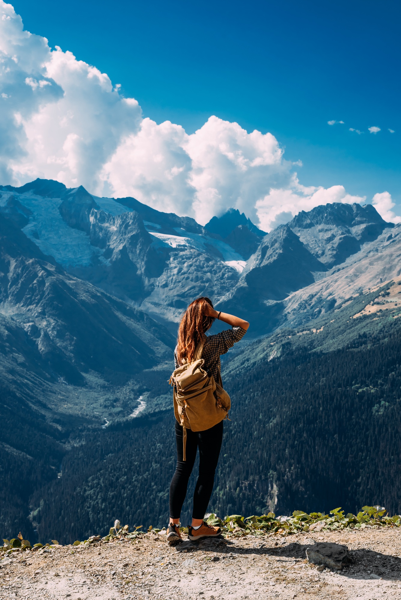 A woman is traveling in Caucasus, Russia. Mountain tourism in Russia