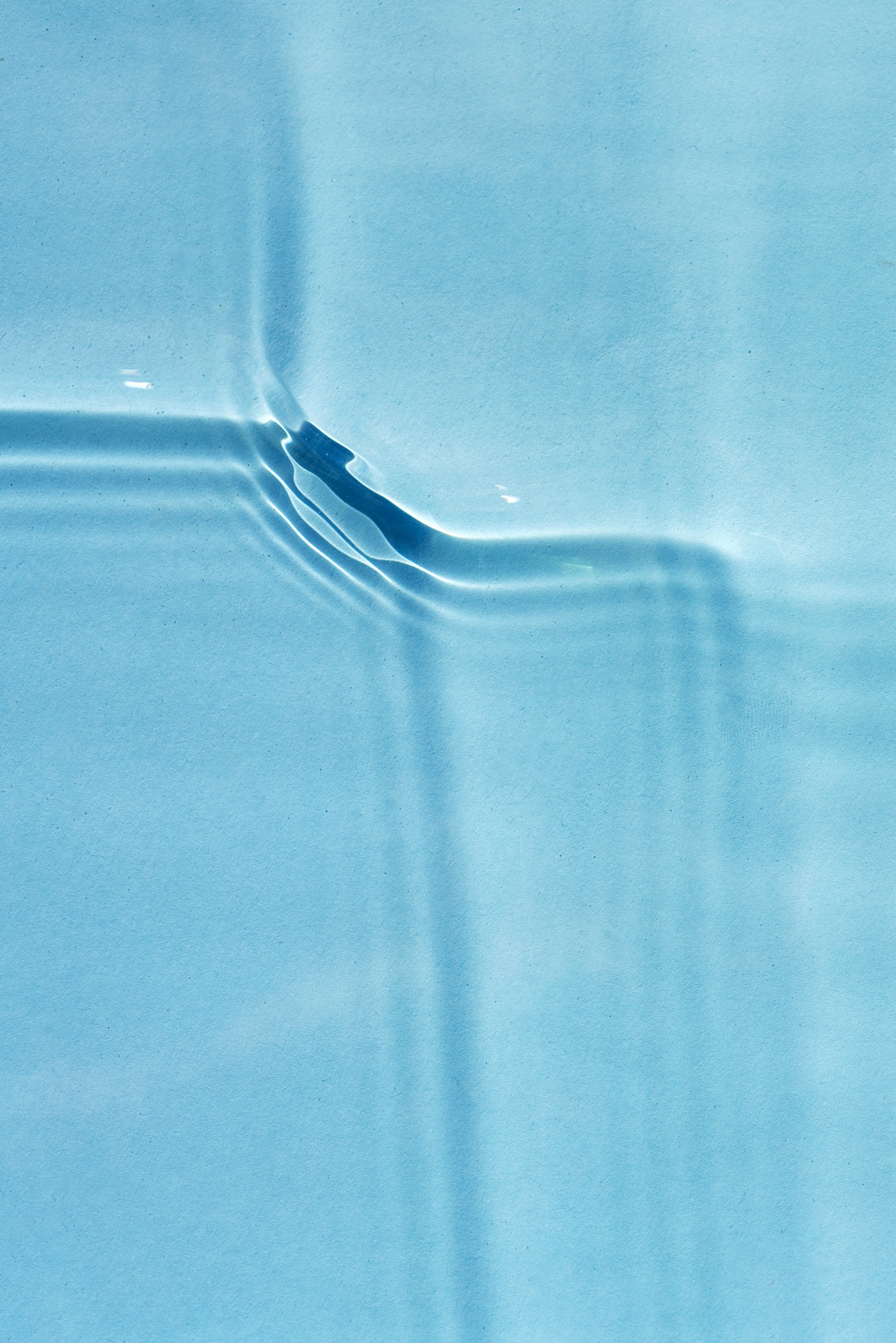 Beautiful sound waves on a transparent surface of blue water