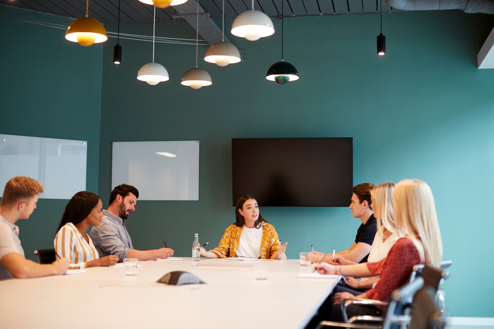 Businesswoman Addressing Group Of Candidates Meeting Around Table