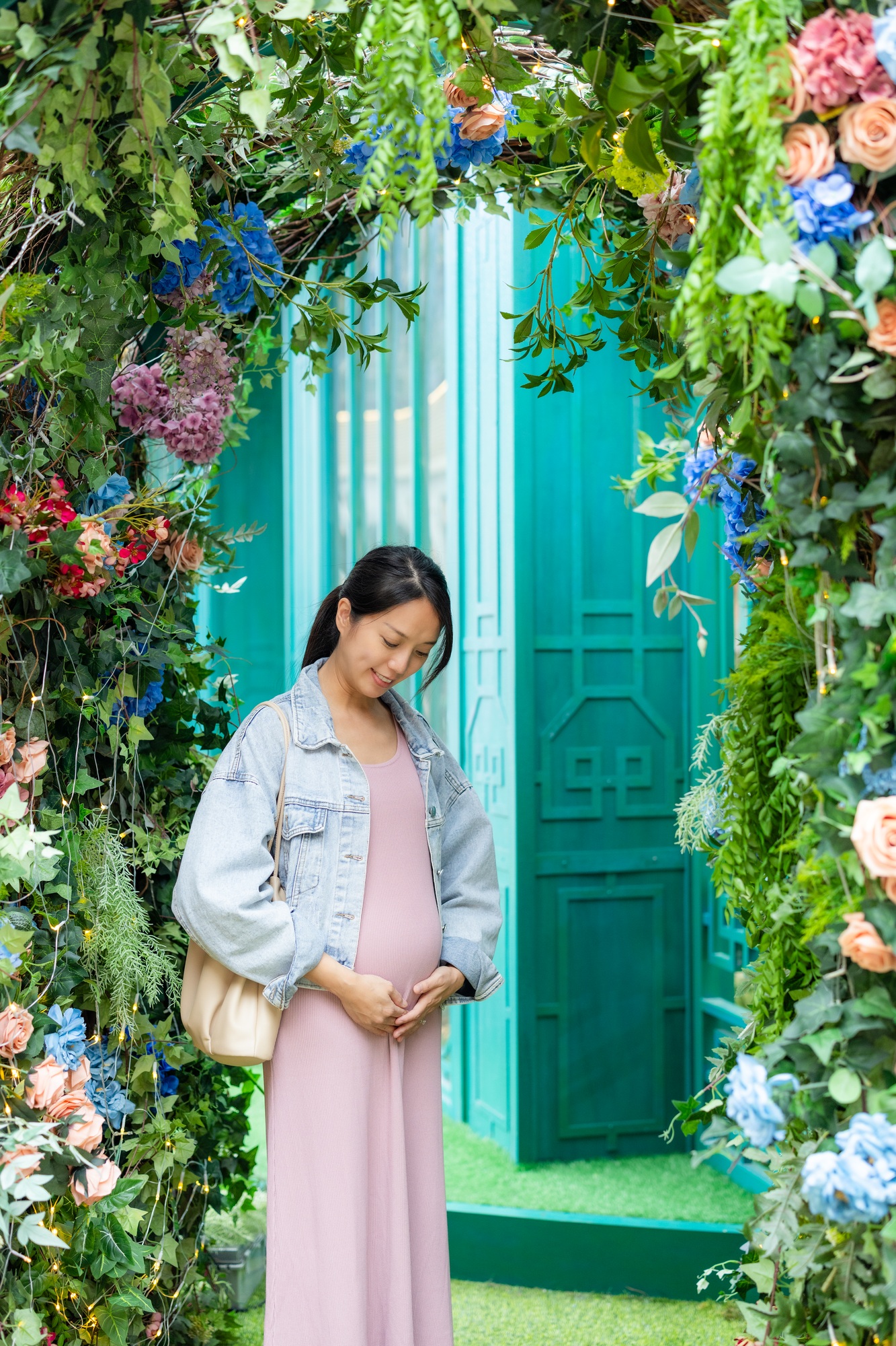 Pregnant woman look at the belly at outdoor