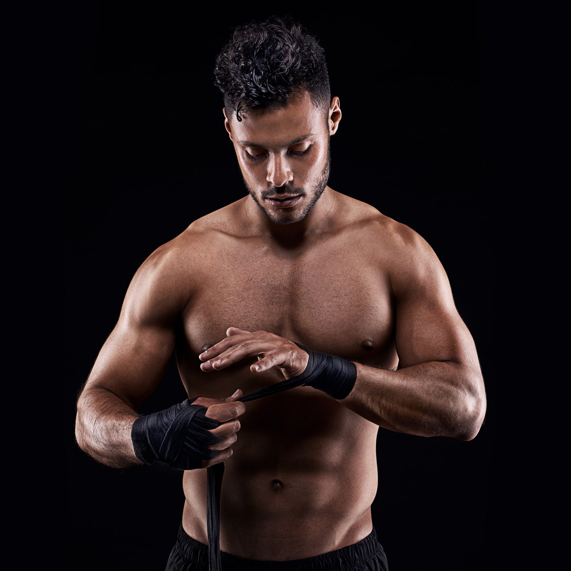 Proper preparation prevents poor performance. Studio shot of a young boxer isolated on black.